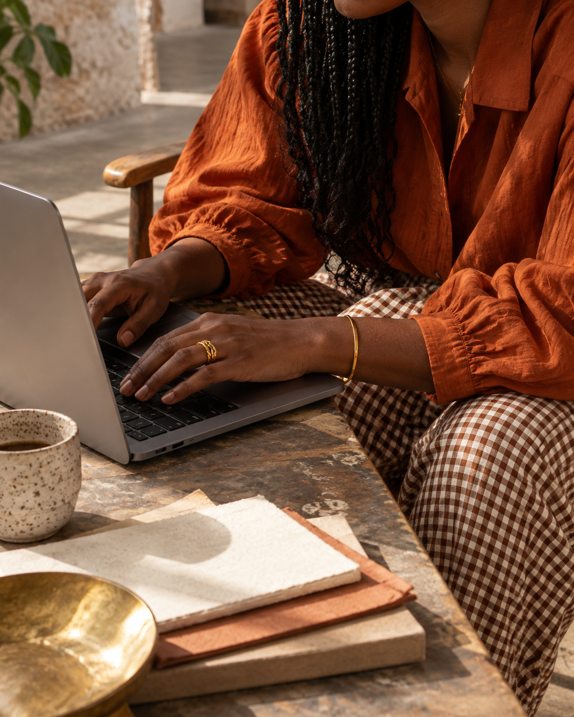 Woman working at a laptop in warm afternoon light